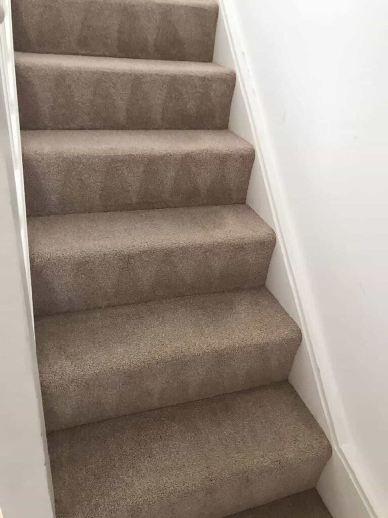 This is an after photo of a staircase with a beige carpet that has been cleaned works carried out by Herne Hill Carpet Cleaning.